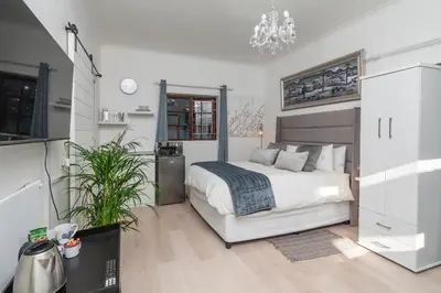 a bedroom with a bed and a desk at Platinum Haven Aparment in Milnerton in Cape Town