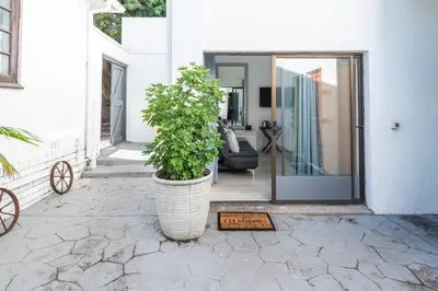 a plant in a large pot on a patio at Platinum Haven Aparment in Milnerton in Cape Town