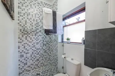 a bathroom with a toilet and a sink at Platinum Haven Aparment in Milnerton in Cape Town