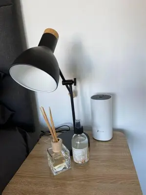 a desk with a lamp and a bottle on a table at 31Ridge Road in Durbanville