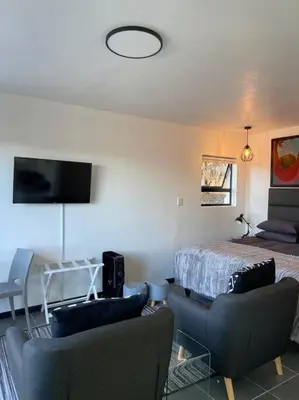 a living room with a bed and two couches at 31Ridge Road in Durbanville