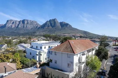 a view of cape town with mountains in the background at Stylish 2-Bed Flat with Exclusive Patio - Easy Access to Cape Town Highlights in Cape Town