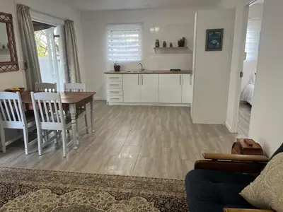 a kitchen and living room with a table and a table and chairs at Mozart Close Durbanville- for people who needs space in Durbanville
