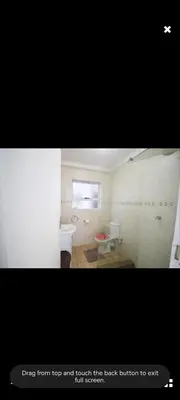 a bathroom with a sink and a toilet at Sea View Room in Gordonʼs Bay