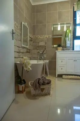 a bathroom with a tub and a sink and a mirror at Hephzibah inn Guest house and venue in Hermon