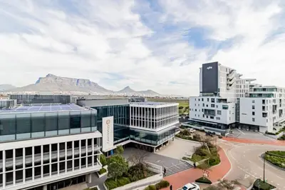 an aerial view of buildings with mountains in the background at 1 bed flat with Mountain view in Cape Town