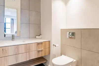 a bathroom with a toilet and a sink and a mirror at 1 bed flat with Mountain view in Cape Town