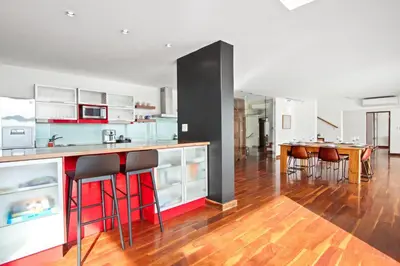 a kitchen with a bar with stools at Restio View 11 in Cape Town