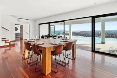 a large dining room with a table and chairs at Restio View 11 in Cape Town