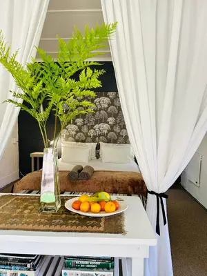 a plate of fruit on a table in a bedroom at Agapanthus garden cottage in Grabouw