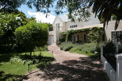a house with a pathway leading to it at Jonquil Guest Cottage in Franschhoek