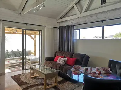 a living room with a couch and a table at Coastal Cozy Home in Cape Town