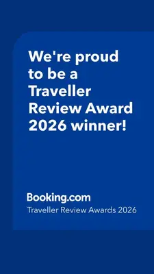 a blue sign that says were proud to be a traveller reviewagency winner at Bloubergstrand Beachfront Apartment Witsand 101 in Cape Town