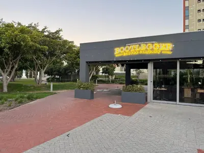 a building with a sign on the front of it at Waters Edge in Cape Town