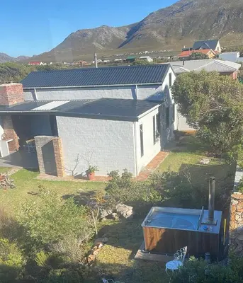 an aerial view of a white house with a yard at Brunia Cottage in Bettyʼs Bay