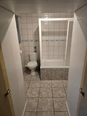 a small bathroom with a toilet and a shower at Urban Retreat in Cape Town