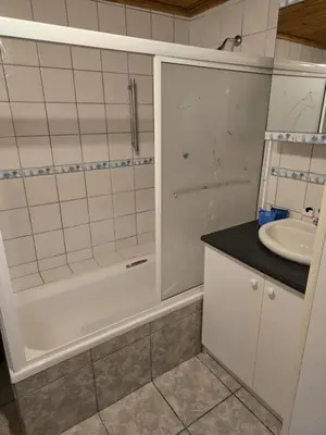 a bathroom with a shower and a sink at Urban Retreat in Cape Town