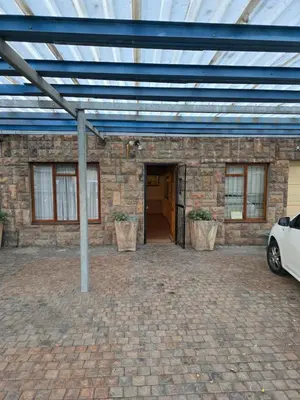 a brick building with a car parked in front of it at Urban Retreat in Cape Town