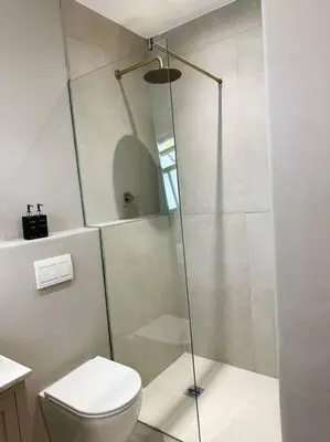 a bathroom with a shower and a toilet at Stellenbosch Winelands Apartment in Stellenbosch