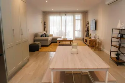 a living room with a table and a couch at 24 Le Bourgette in Franschhoek