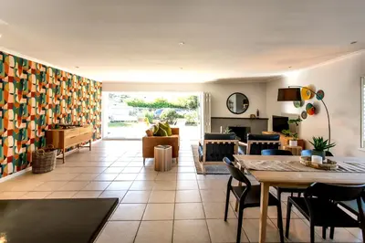 a living room with a table and a couch at Happy Hideaway in Hermanus