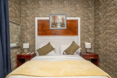 a bedroom with a large bed with two night stands at Prime Executive Accommodation in Cape Town