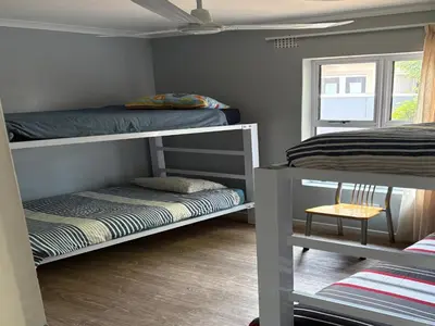 a room with two bunk beds and a window at Tolbos Backpackers in Worcester