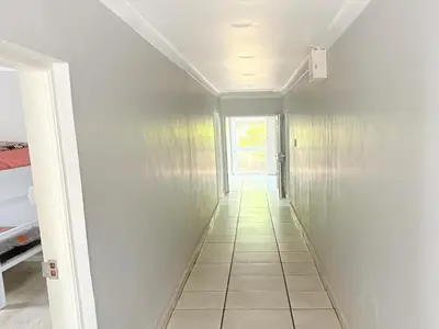 a hallway leading to a room with a window at Tolbos Backpackers in Worcester