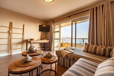 a living room with a couch and two tables with animal heads on them at Beachfront Luxury Living- A106 Seaspray, Blouberg in Bloubergstrand