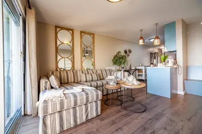 a living room with a couch and a table at Beachfront Luxury Living- A106 Seaspray, Blouberg in Bloubergstrand