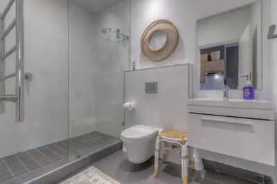 a bathroom with a toilet and a sink and a shower at Trebuchet Studio Apartment in Somerset West
