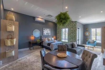 a living room with a couch and a table at Trebuchet Studio Apartment in Somerset West