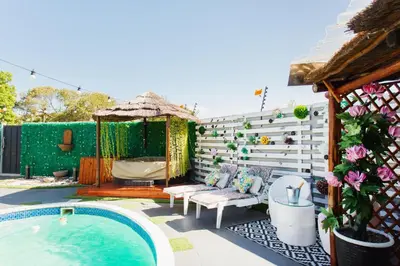 a backyard with a swimming pool and a house at Caline VIP Luxury Jacuzzi &, Swimming Pool MEWS in Cape Town