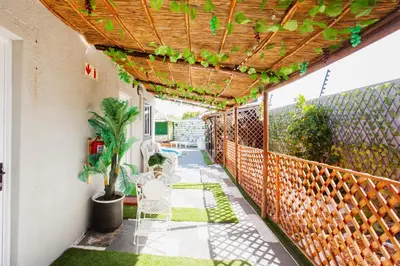 a patio with a table and chairs under a pergola at Caline VIP Luxury Jacuzzi &, Swimming Pool MEWS in Cape Town