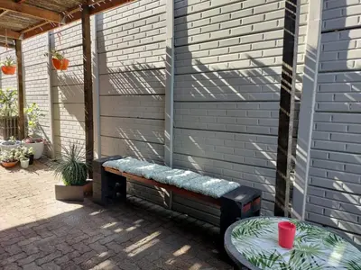 a bench on the side of a house at Champers in Cape Town