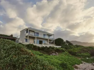 a house on the side of a hill at Seascape, Vermont Retreat in Hermanus