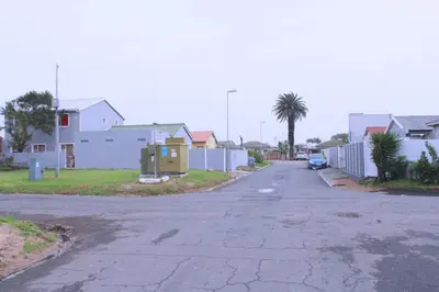 an empty street in a residential neighborhood with houses at Brooklyn Queens and Kings Guesthouse in Cape Town