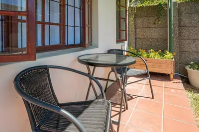 two chairs and a table on a patio at Cape Explore in Cape Town
