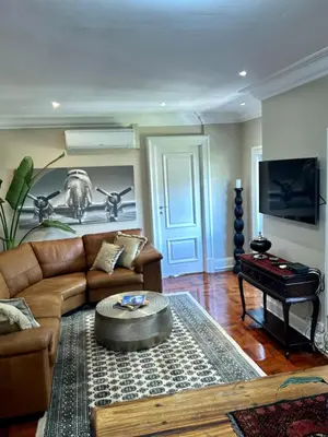 a living room with a couch and a table at French Manor 2 Stellenbosch in Stellenbosch