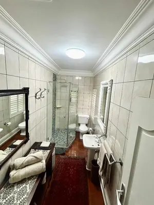a bathroom with a shower and a toilet and a sink at French Manor 2 Stellenbosch in Stellenbosch