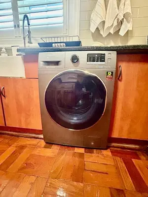 a washing machine is sitting in a kitchen at French Manor 2 Stellenbosch in Stellenbosch