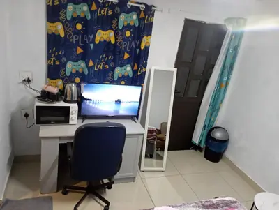 a desk with a computer and a chair in a room at The trout Lodge in Cape Town
