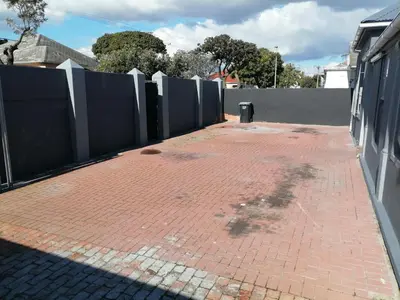 a brick sidewalk next to a fence at 37 Grant prix lodge in Cape Town