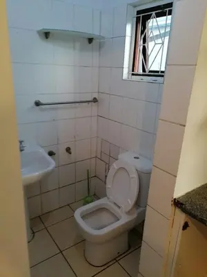 a bathroom with a toilet and a sink at 37 The trout Lodge in Cape Town