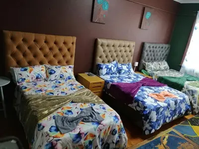 a bedroom with two beds and a bedskirts at 37 The trout Lodge in Cape Town