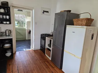 a kitchen with a refrigerator and a stove at Greyt House selfcatering house in Greyton SA in Greyton