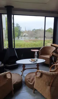 a living room with a table and chairs and a window at Greyt House selfcatering house in Greyton SA in Greyton