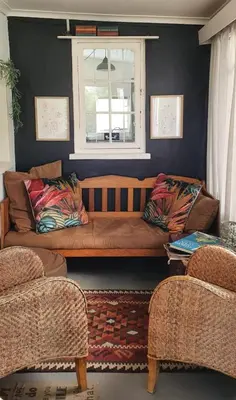a living room with a brown couch and a window at Greyt House selfcatering house in Greyton SA in Greyton