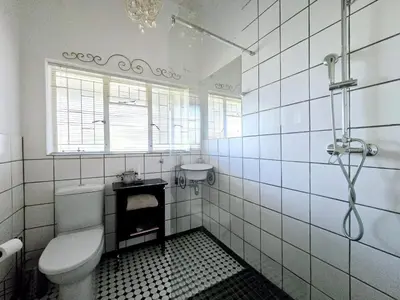 a white bathroom with a toilet and a sink at Greyt House selfcatering house in Greyton SA in Greyton