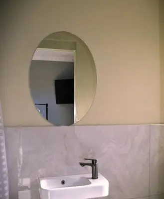 a bathroom with a sink and a mirror at 160 On Townsend Guesthouse in Cape Town